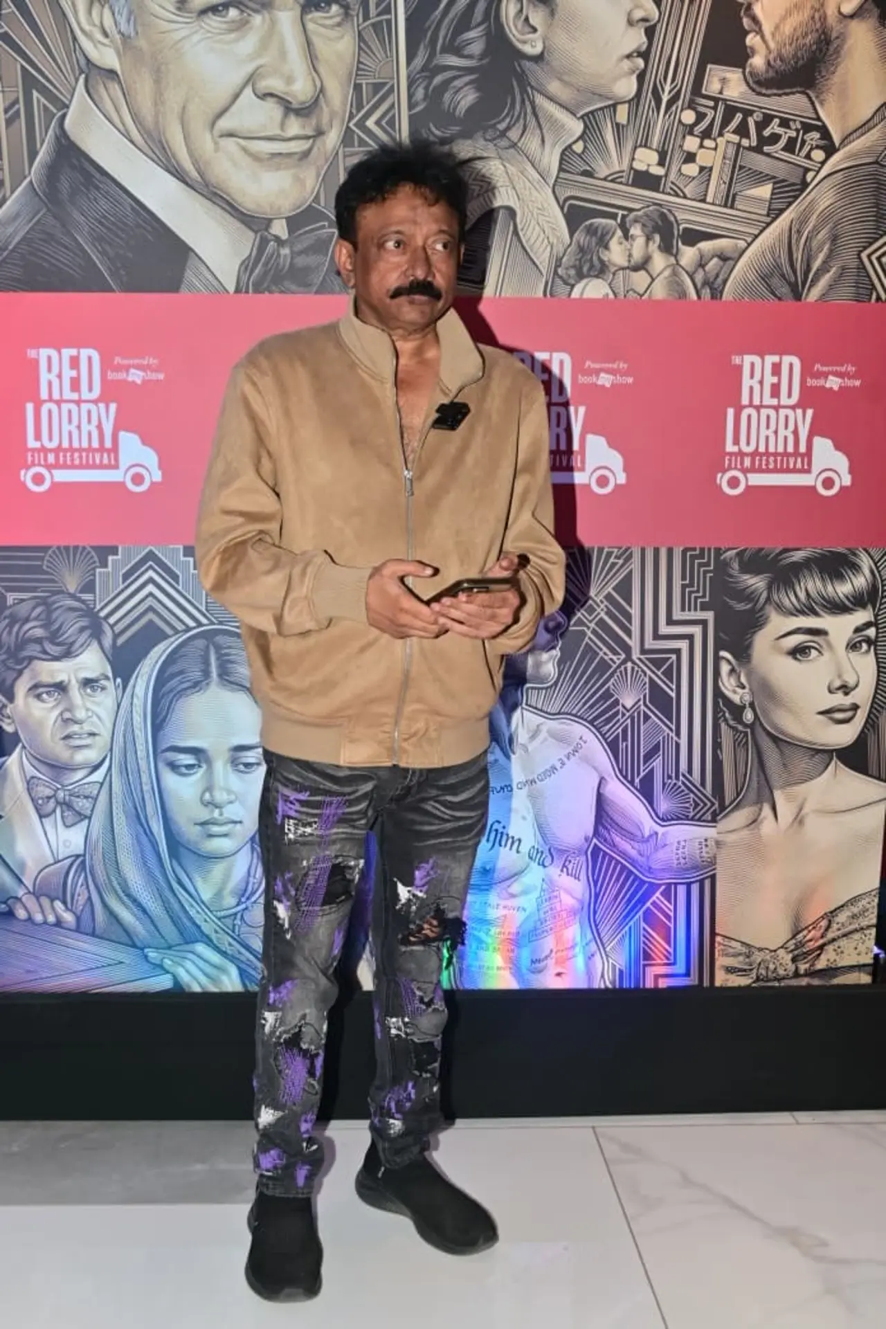 Ram Gopal Varma made an appearance at the Red Lorry Film Festival, posing for the cameras on the red carpet.